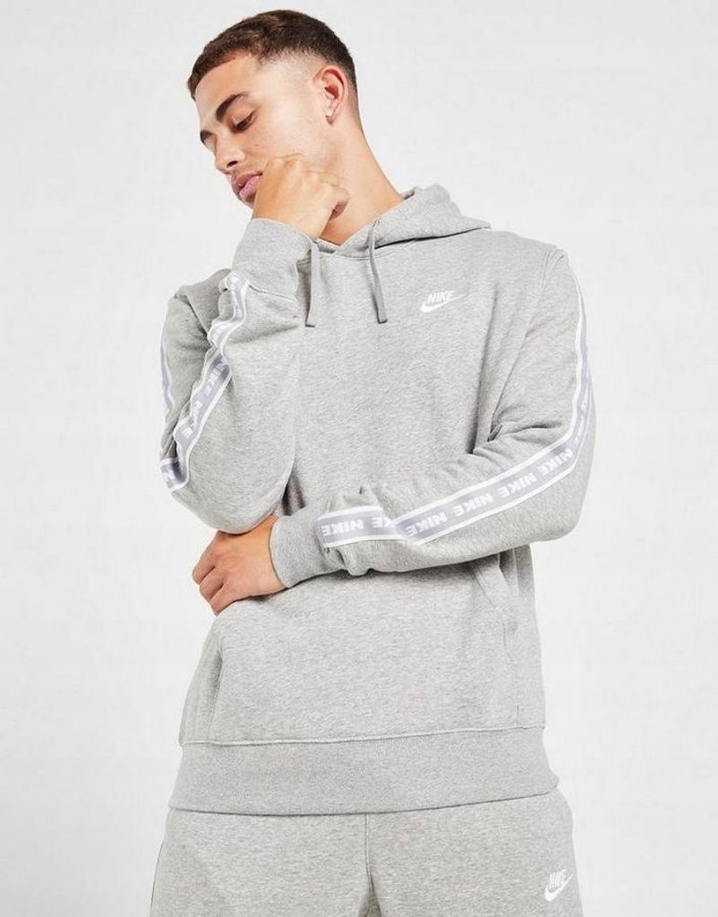 A man wearing a grey Nike tracksuit.