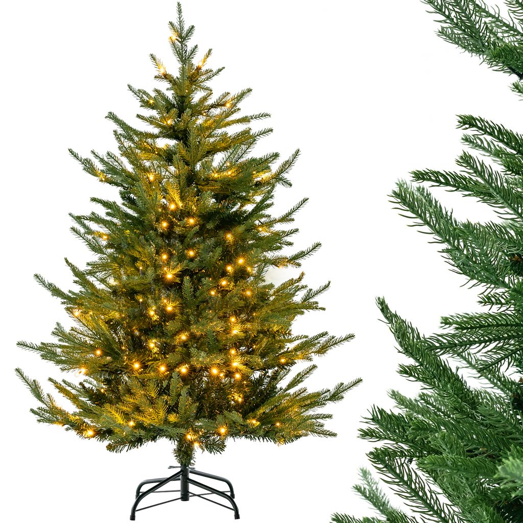 A pre-lit artificial Christmas tree on a white background, with a close-up of another Christmas tree branch on the right.