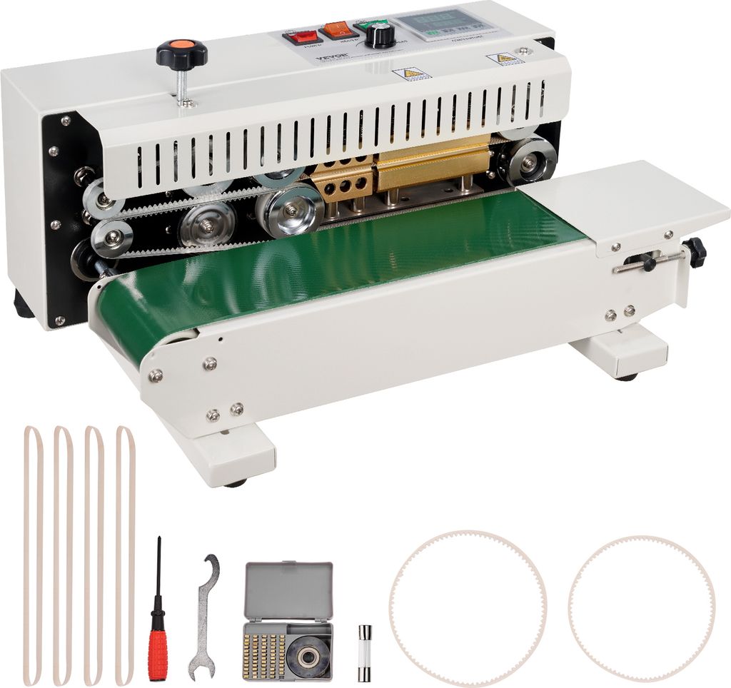 A white continuous band sealing machine with a green conveyor belt is shown on a white background. Several accessories are laid out in front of the machine.