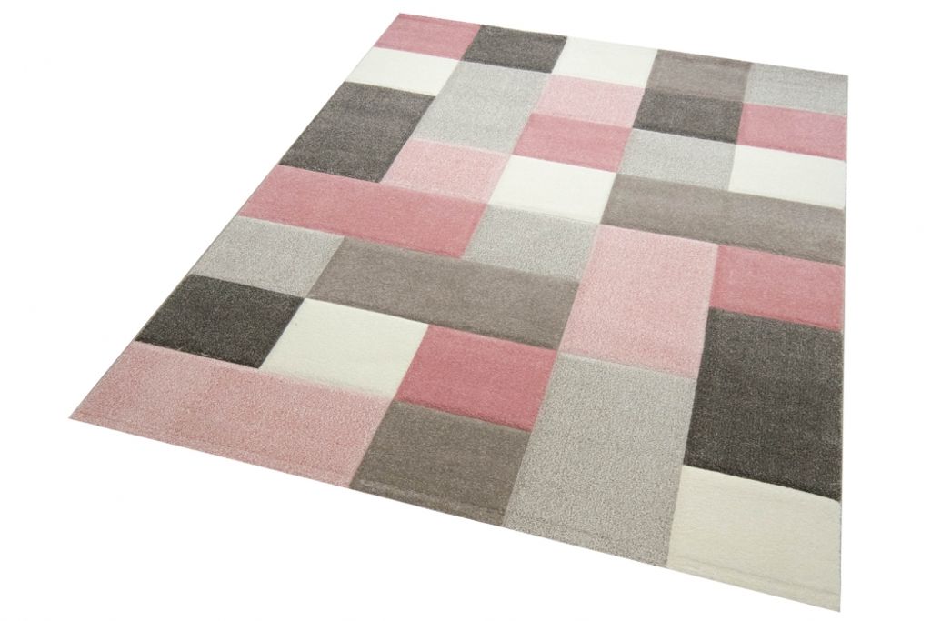 A close-up, angled view of a rug with a geometric pattern.
