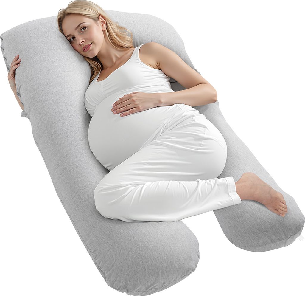 A pregnant woman is lying on a U-shaped pillow.