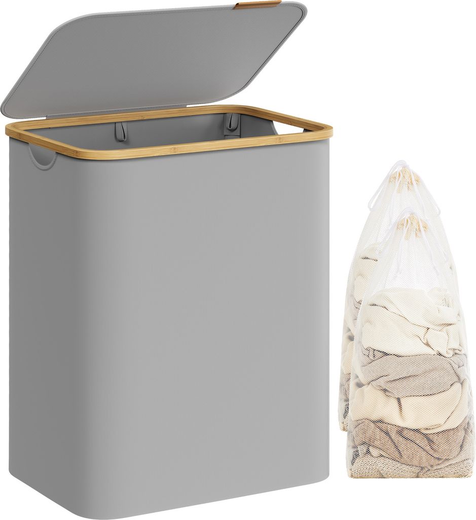 A grey laundry basket with a bamboo rim and lid, next to two laundry bags filled with clothes.