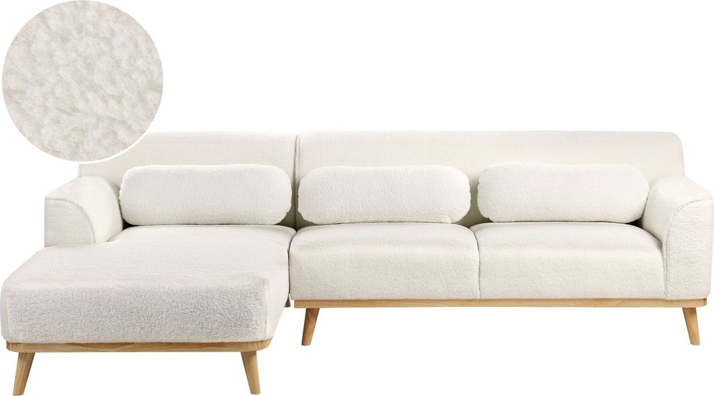A white bouclé fabric sectional sofa with a chaise lounge on a white background.