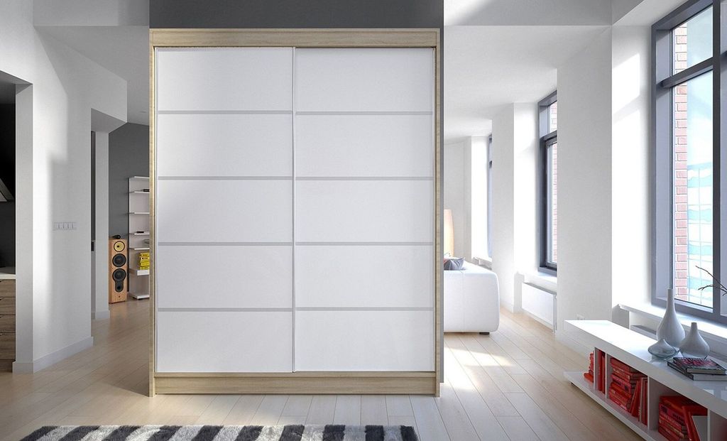 A modern hallway with a large sliding door wardrobe, leading into a bright living room with large windows.