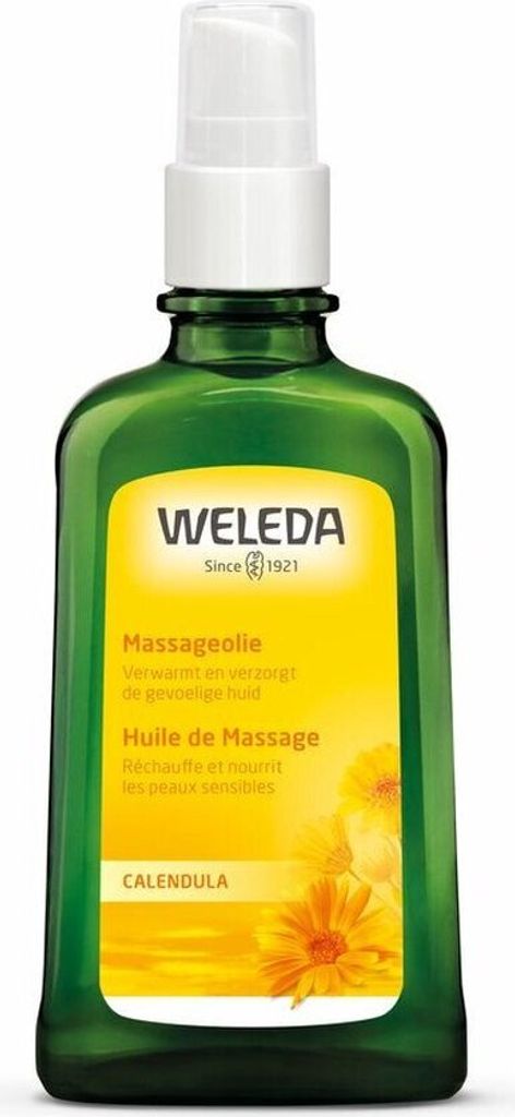 A green glass bottle of Weleda massage oil with a yellow label featuring images of calendula flowers.