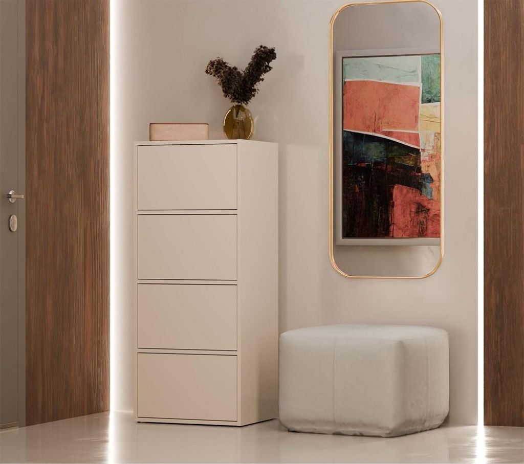 A hallway with a tall cabinet, a mirror, and a pouf.