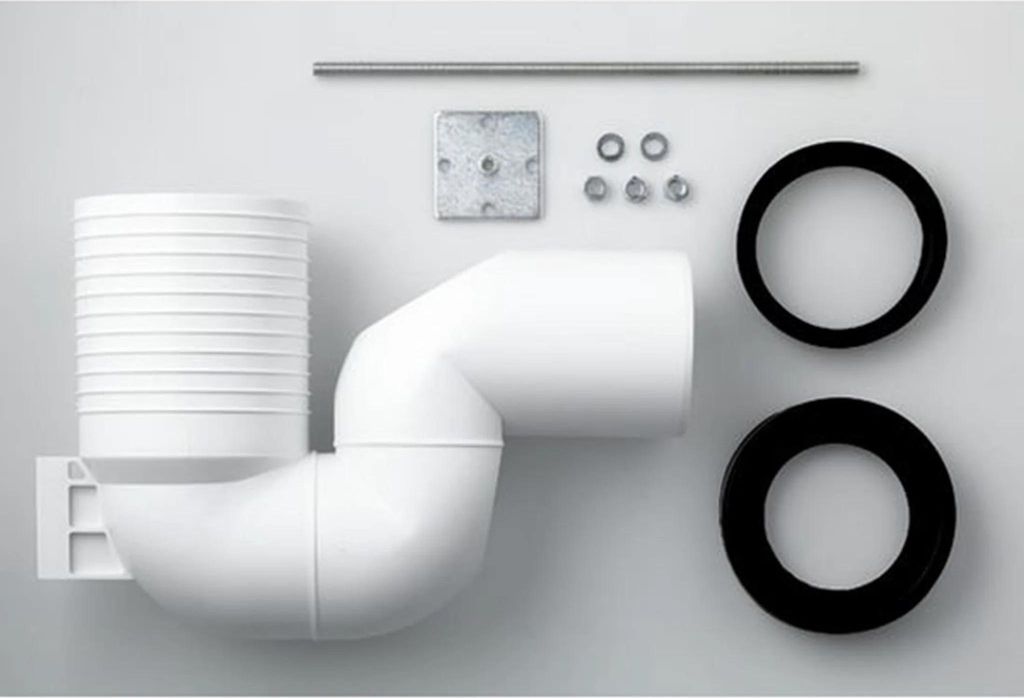 A collection of plumbing parts laid out on a light gray background.
