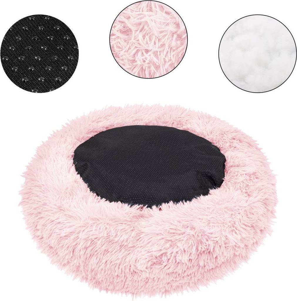 A round, fluffy pink pet bed with a black center cushion. Three circular insets show close-ups of the materials: a black textured fabric with small dots, fluffy pink material, and white stuffing.