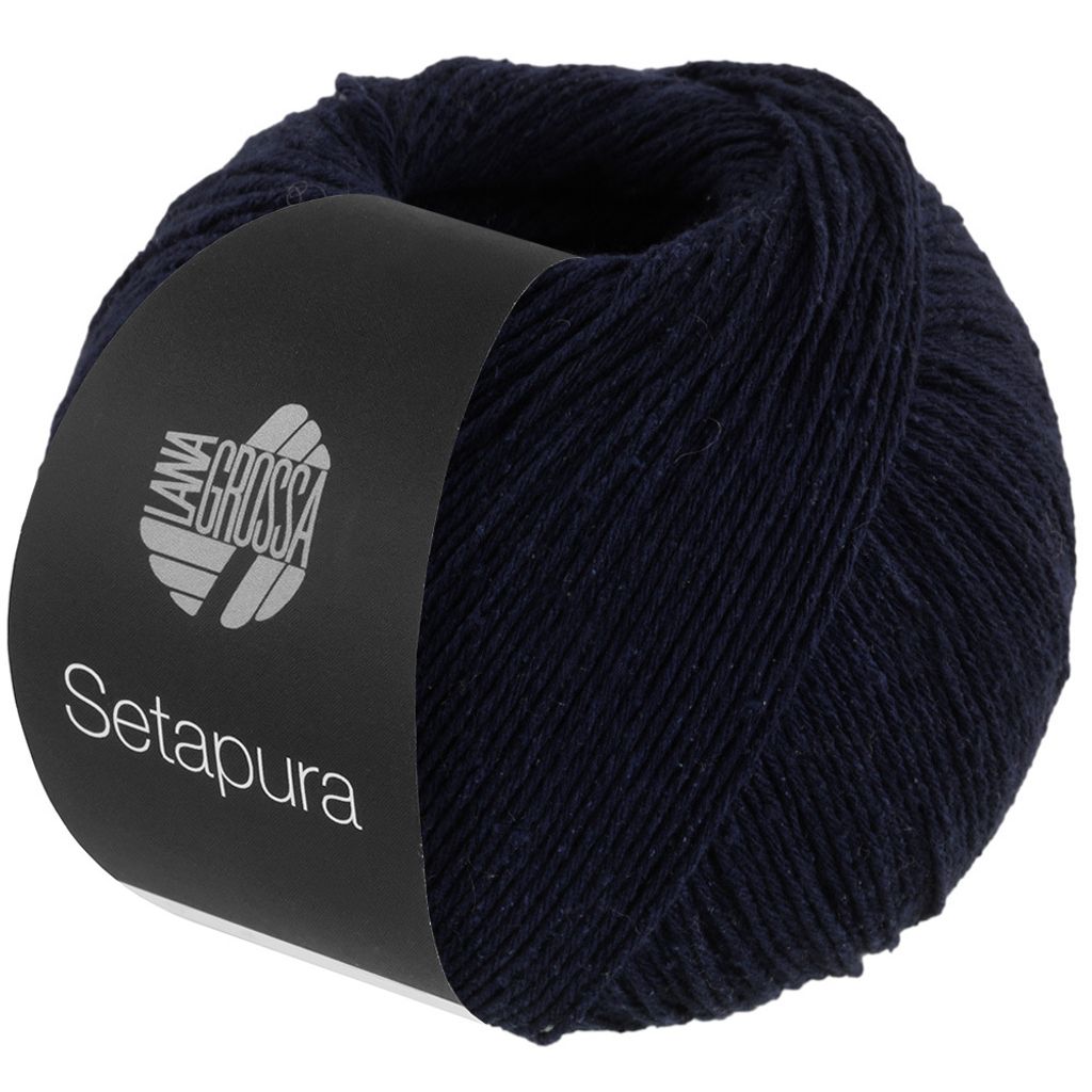 A ball of dark blue yarn with a black label wrapped around it.