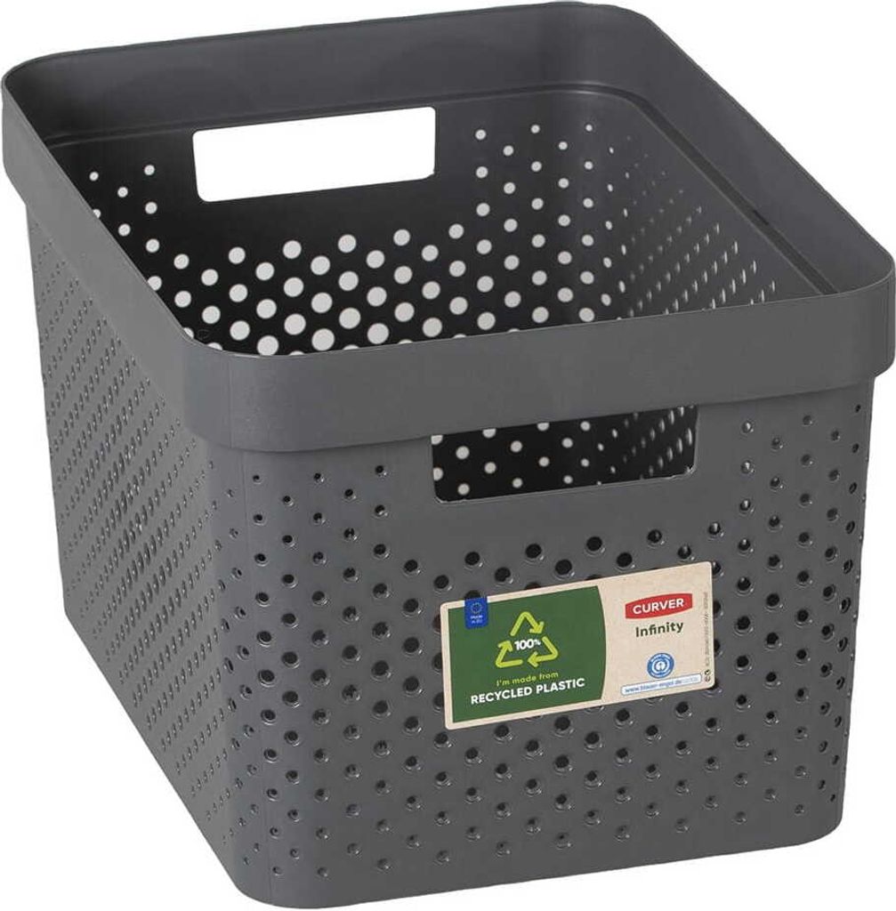 A dark gray storage basket with a perforated design and white polka dots on the inside.