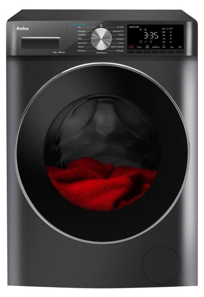 A front view of a black Amica washing machine with red laundry inside the drum.