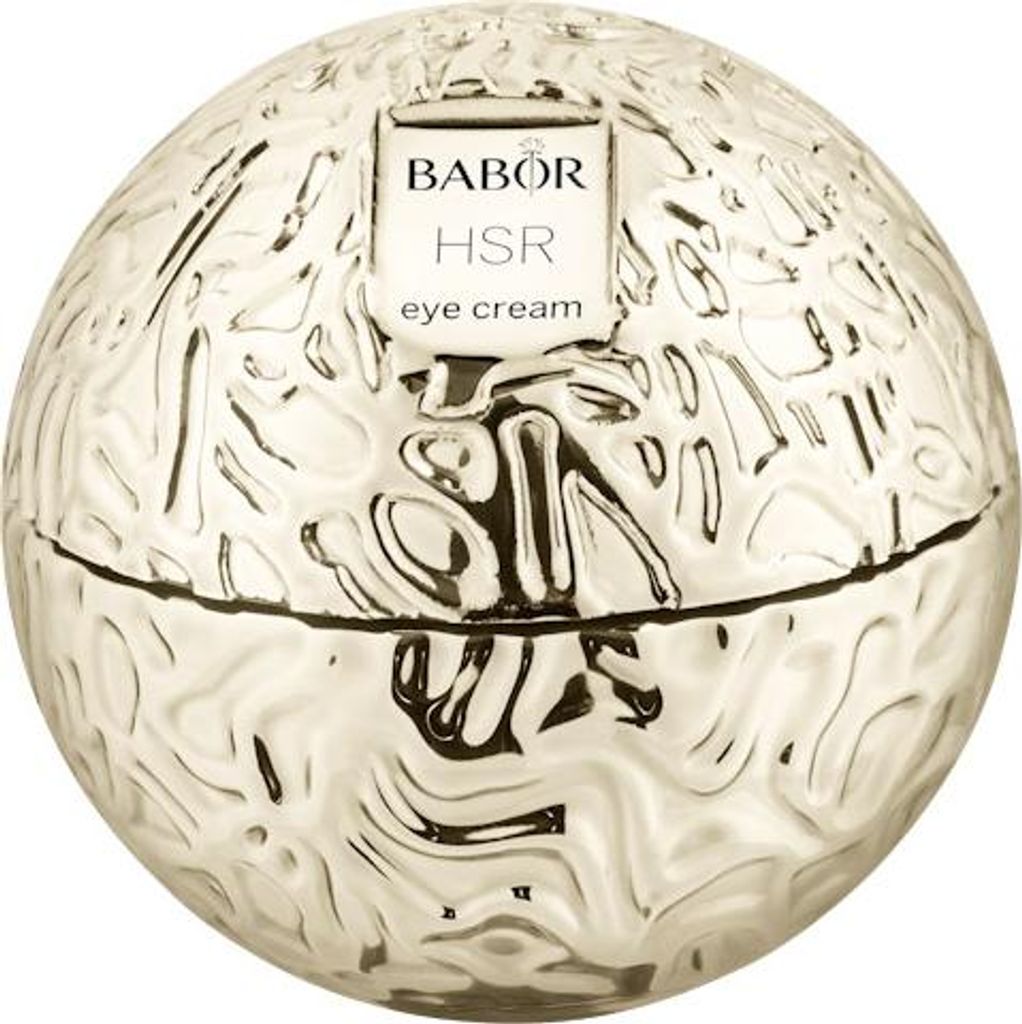 A round, textured gold container for eye cream, with a label on top.