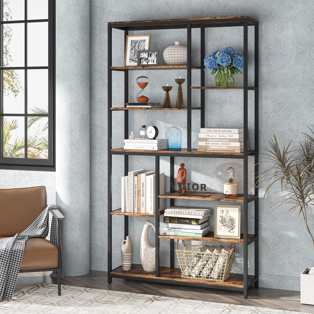 A tall, multi-shelf bookcase filled with decorative items and books, placed in a room with a window and a chair.
