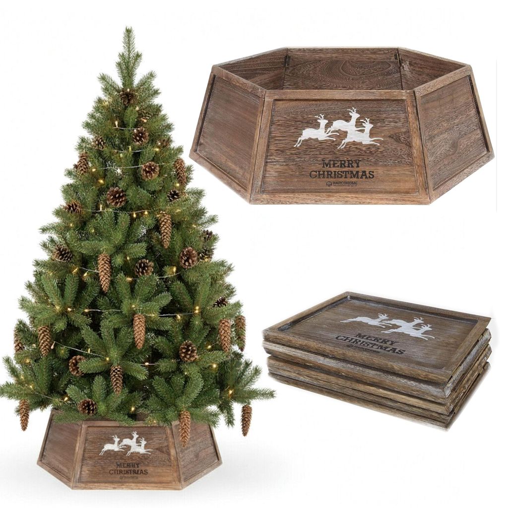 A Christmas tree with pinecones and lights, and a wooden tree collar.