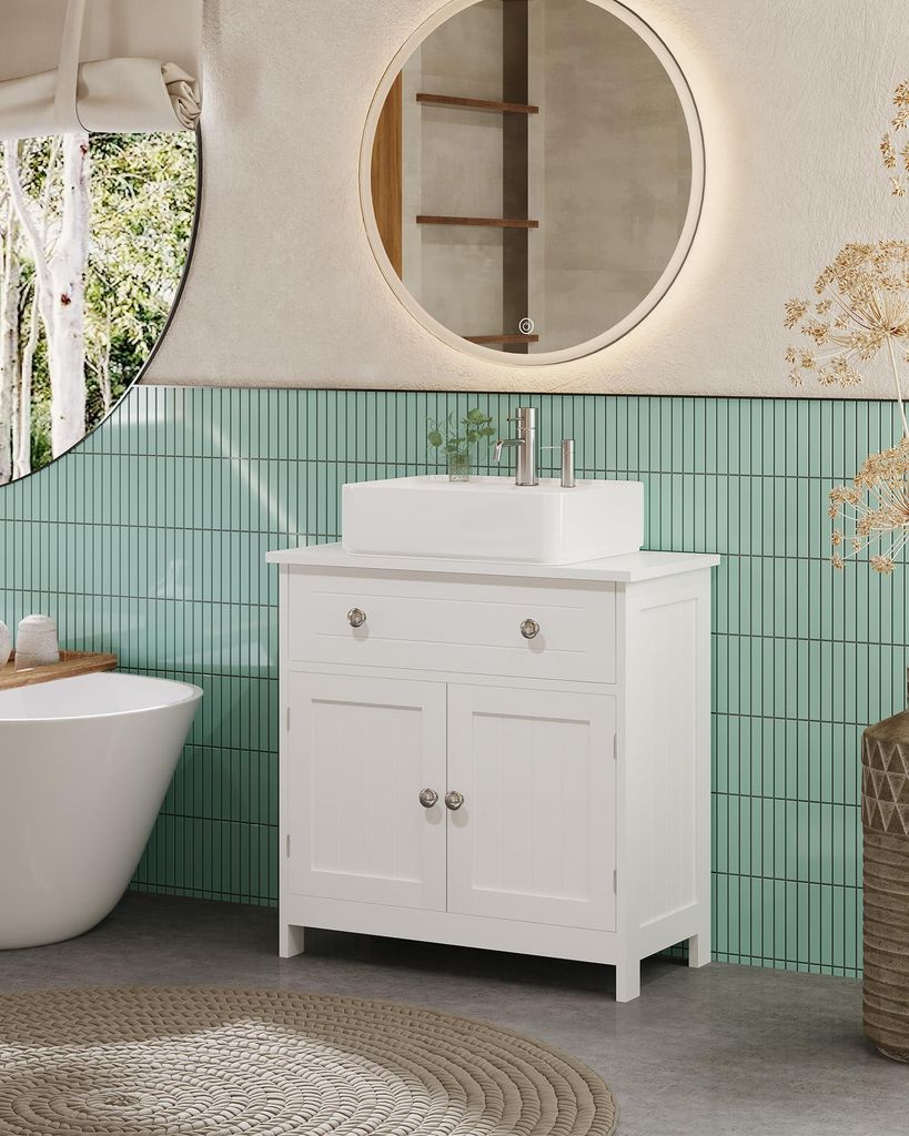 A modern bathroom with a white vanity, sink, and bathtub.