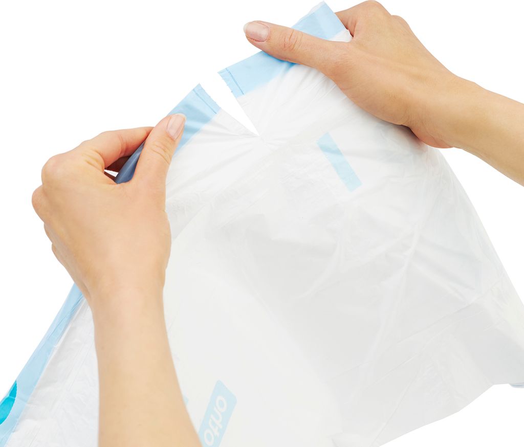 Hands holding a white plastic bag with blue trim, tearing it open.