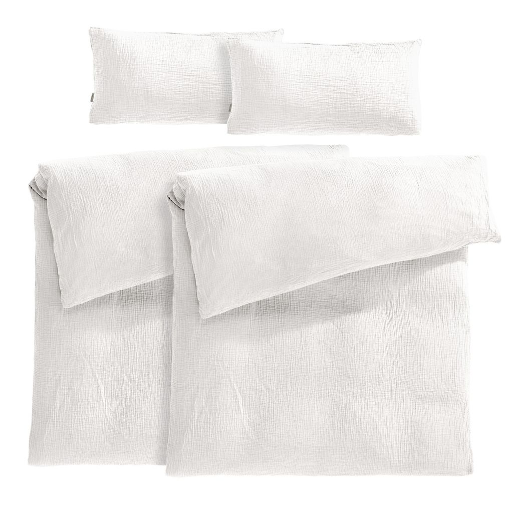 A set of white bedding, including two duvet covers and two pillowcases, neatly folded and arranged.