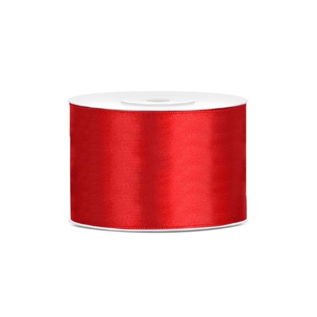 A roll of red satin ribbon on a white background.