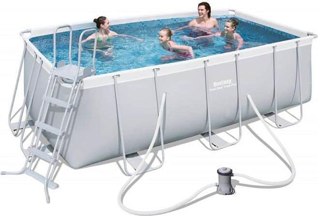 A family is enjoying a rectangular above-ground swimming pool with a ladder and filter system.