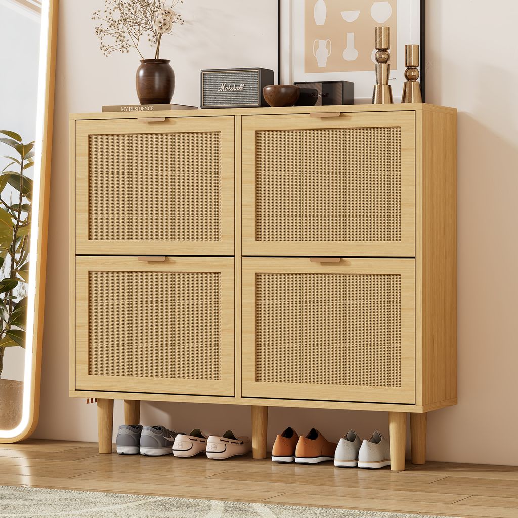 A shoe cabinet with rattan doors and wooden legs, with shoes placed underneath.