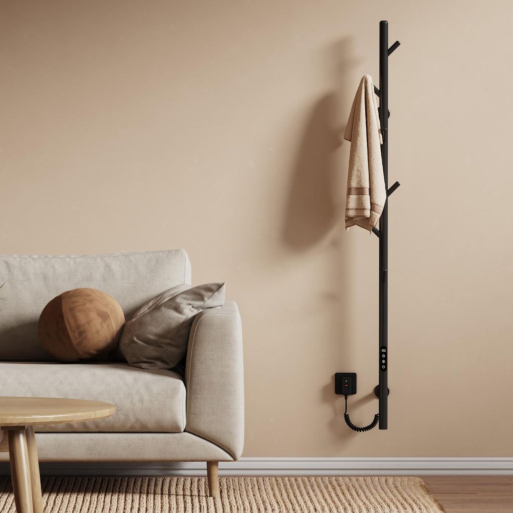 A modern living room with a sofa, coffee table, and a wall-mounted electric towel warmer.