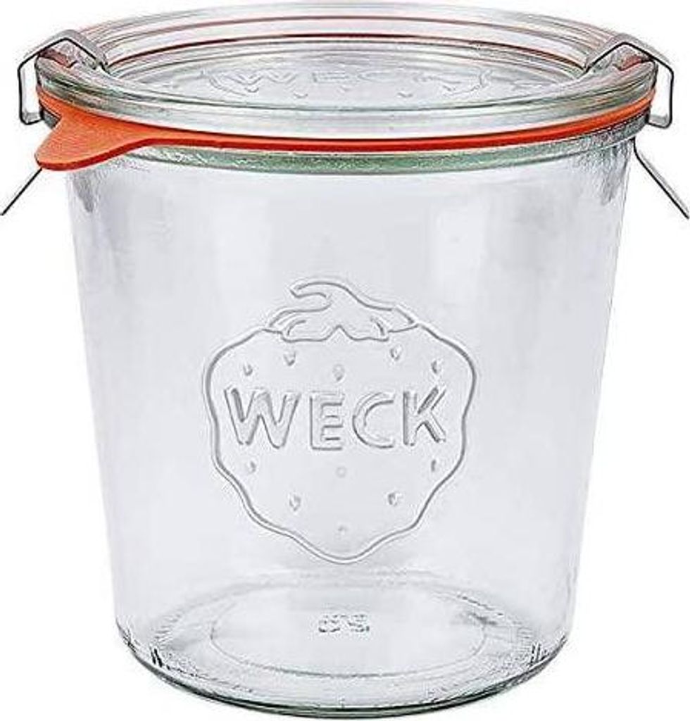 A clear glass Weck jar with an orange rubber seal and metal clips, shown against a white background.