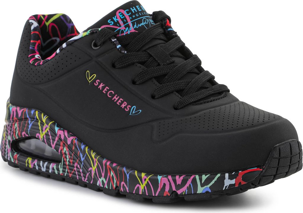 A black Skechers shoe with colorful graffiti-like accents on the sole and interior.