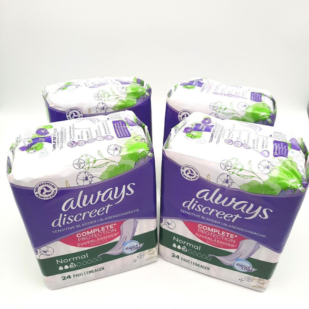 Four packages of Always Discreet sanitary pads are arranged on a white background.