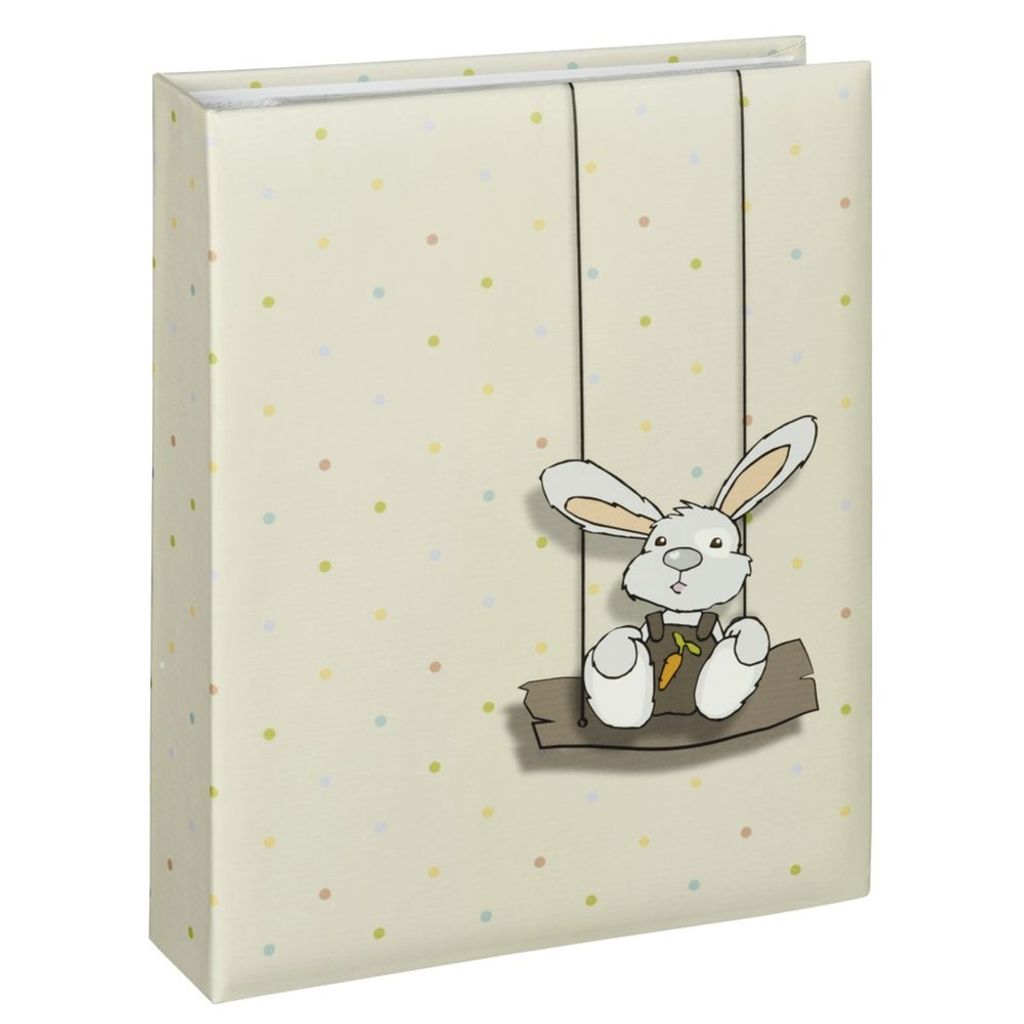 A photo album with a polka dot pattern and a cartoon bunny on a swing.