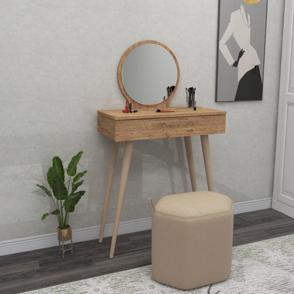 A vanity table with a mirror, stool, and plant in a room setting.