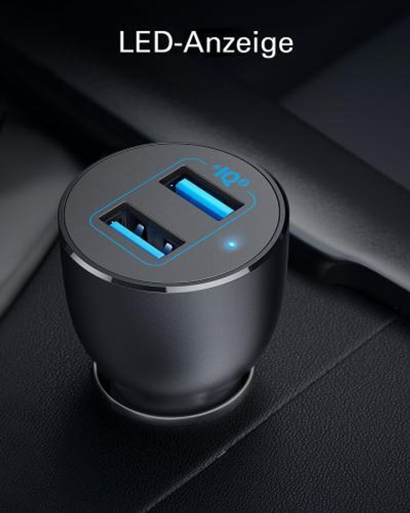 A close-up shot of a black car charger with two blue USB ports, plugged into a car's interior.