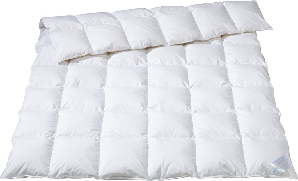 A white duvet or comforter is folded and laid out on a white background.