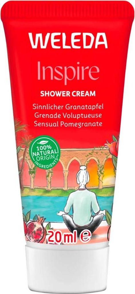 A tube of Weleda Inspire Shower Cream with a depiction of a person meditating by a body of water with an arched structure in the background.
