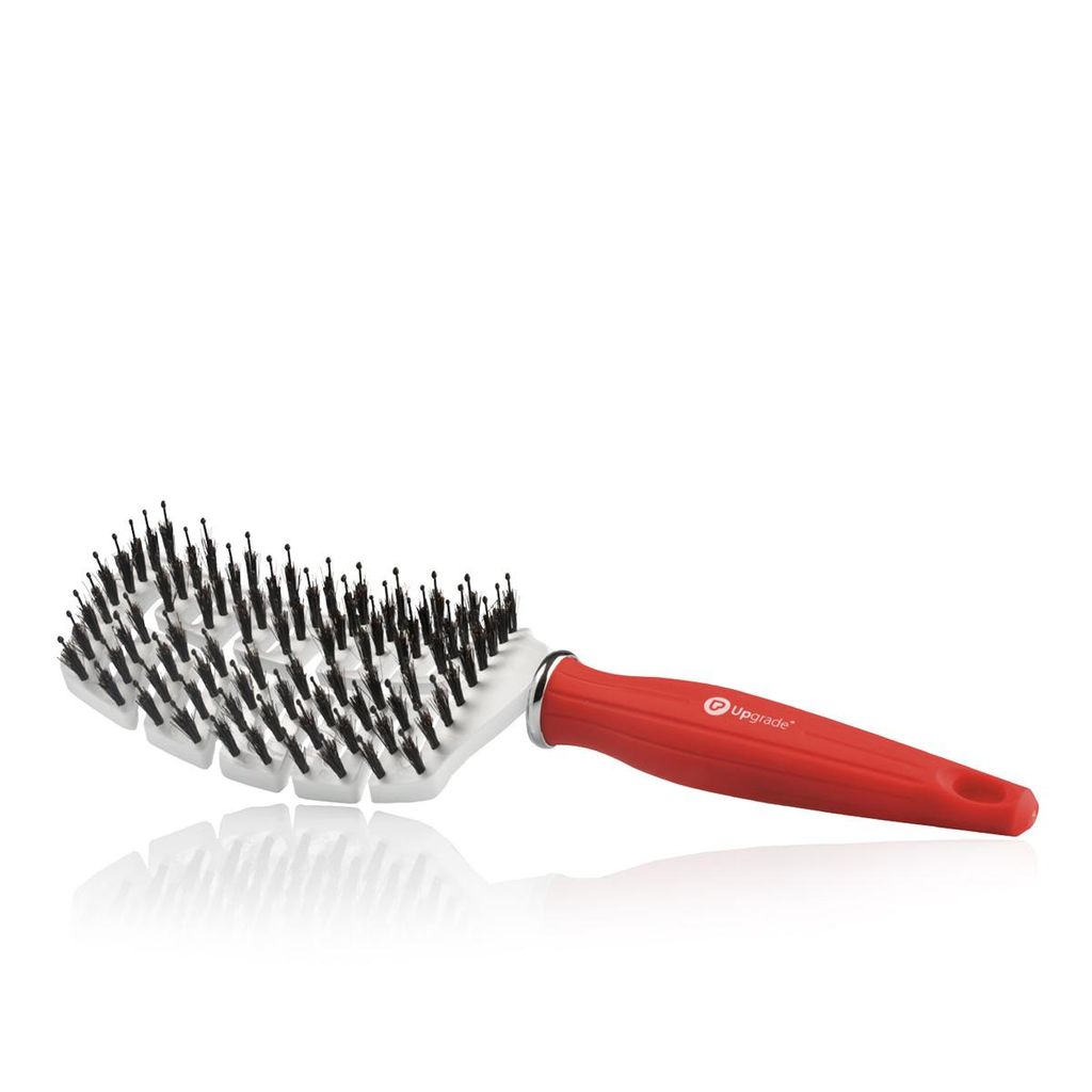 A red and white hairbrush with black bristles is shown against a white background.