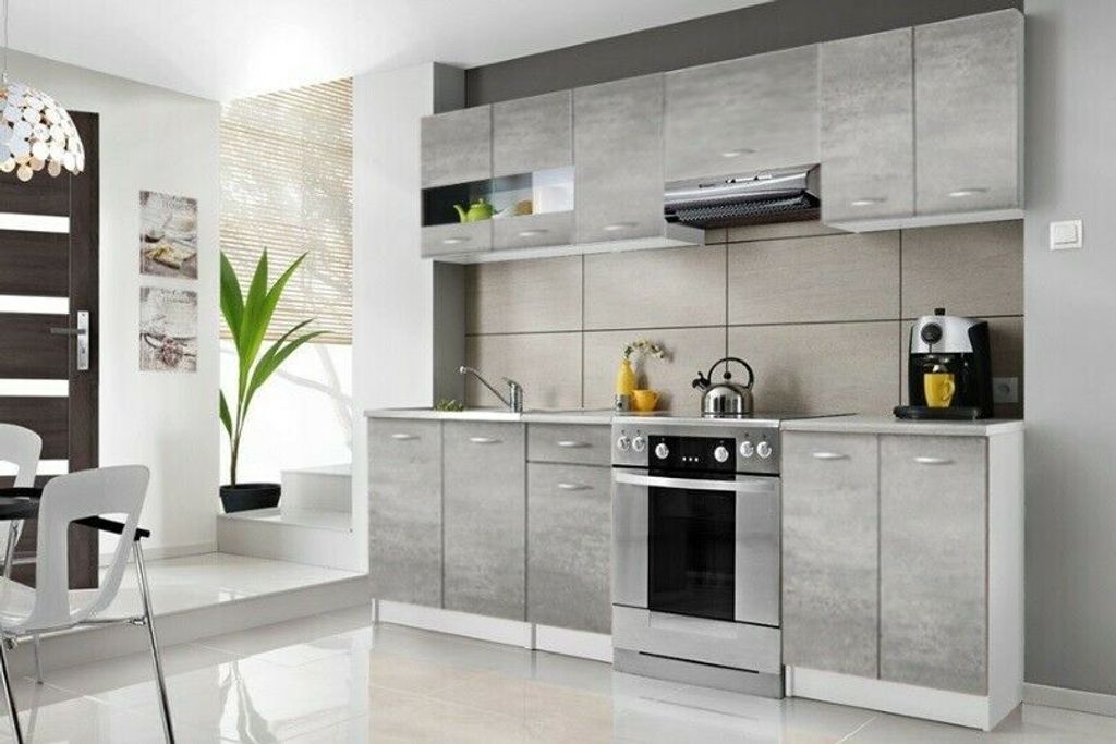 A modern gray kitchen with appliances and cabinets.