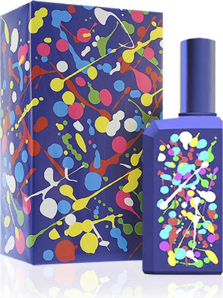 A perfume bottle and its box, both decorated with a colorful paint splatter design on a blue background.