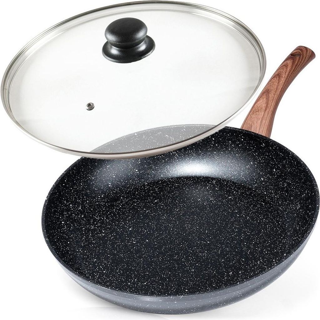 A black frying pan with a speckled surface and a wooden handle, shown with a clear glass lid slightly ajar.