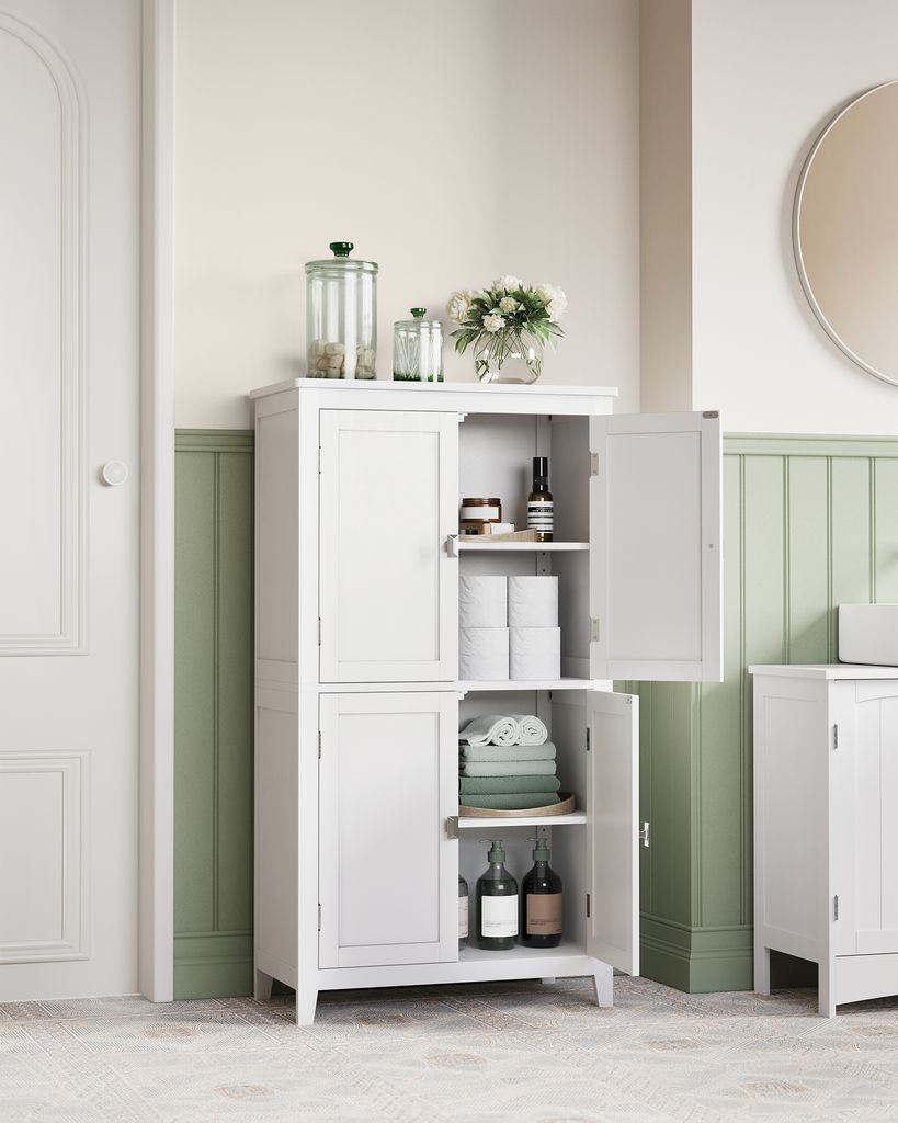 A white cabinet with its doors open, displaying various items inside, set against a light-colored wall with green wainscoting.