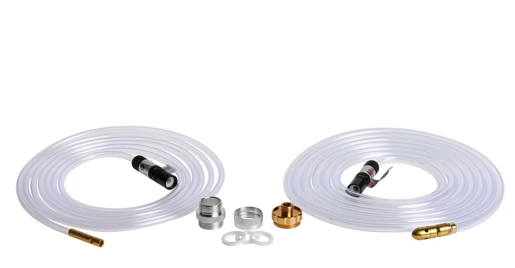 Two coiled clear hoses with metal fittings and several small metal accessories arranged on a white background.