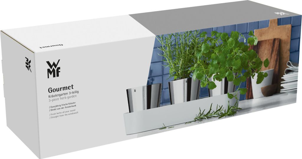 A product box for a WMF Gourmet herb garden set, showing a realistic depiction of the product in use on the right side.