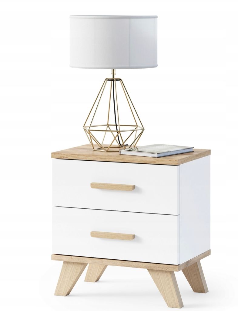 A white nightstand with two drawers and wooden legs, topped with a gold geometric lamp and a book.
