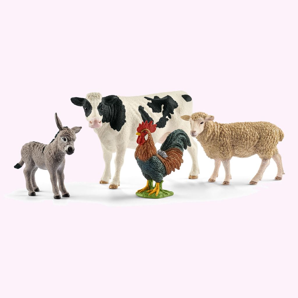 A group of farm animal figurines including a donkey, a cow, a rooster, and a sheep, arranged on a plain background.