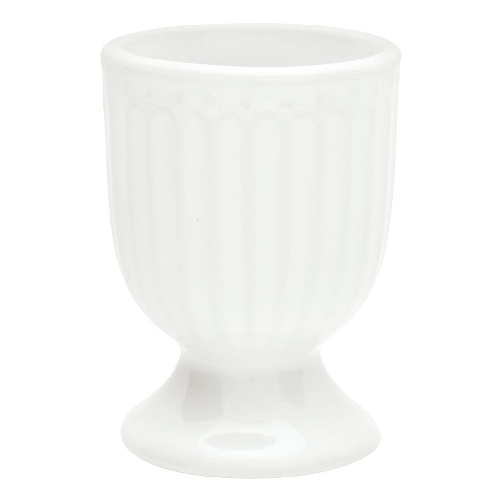 A white ceramic egg cup with vertical ridges and a pedestal base, isolated on a white background.