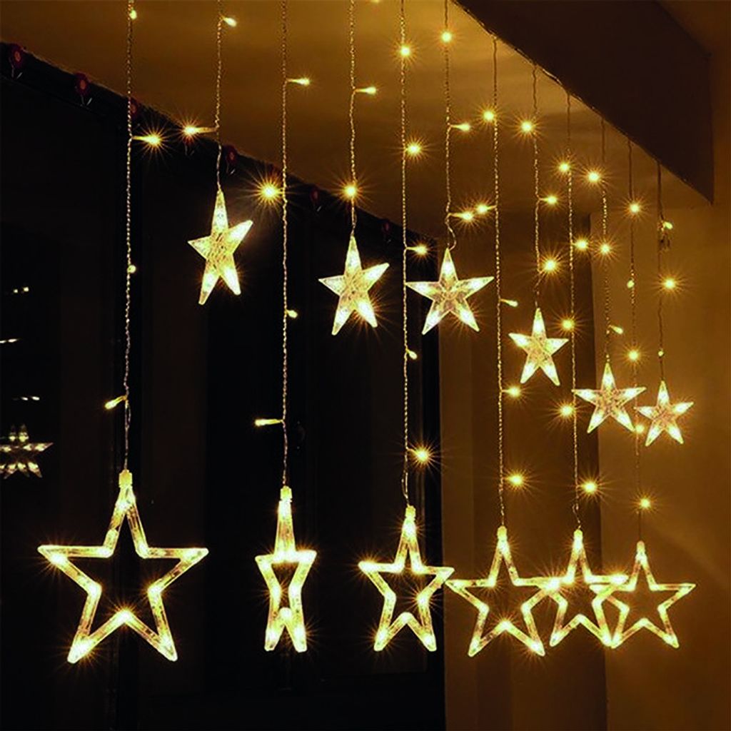 A string of star-shaped lights hanging in front of a dark background.