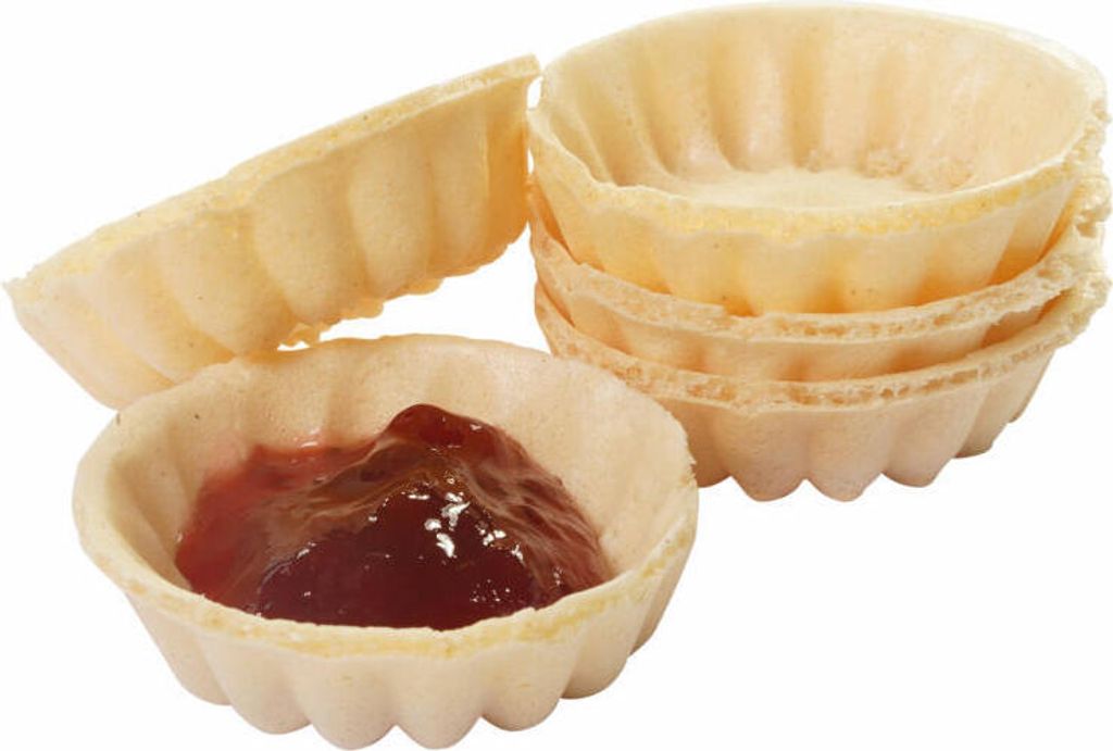 A close-up shot of several empty waffle cups and one filled with jam.