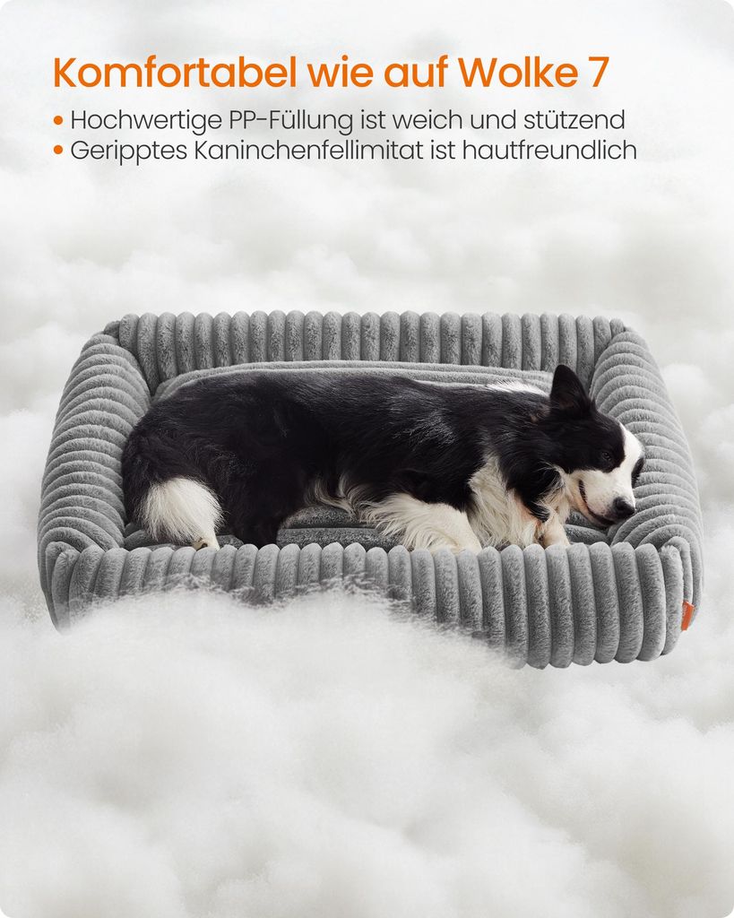 A dog sleeping in a dog bed surrounded by fluffy material.