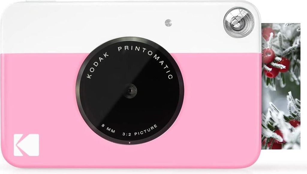 A pink and white Kodak instant print camera is shown from the front.