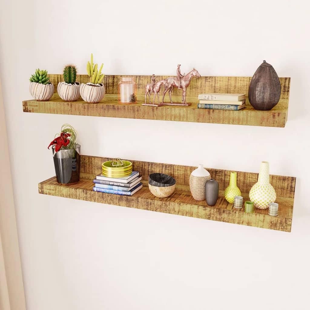 Two wooden shelves mounted on a white wall, decorated with various items.