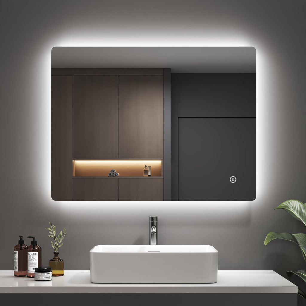 A modern bathroom vanity with a sink and a large LED mirror.