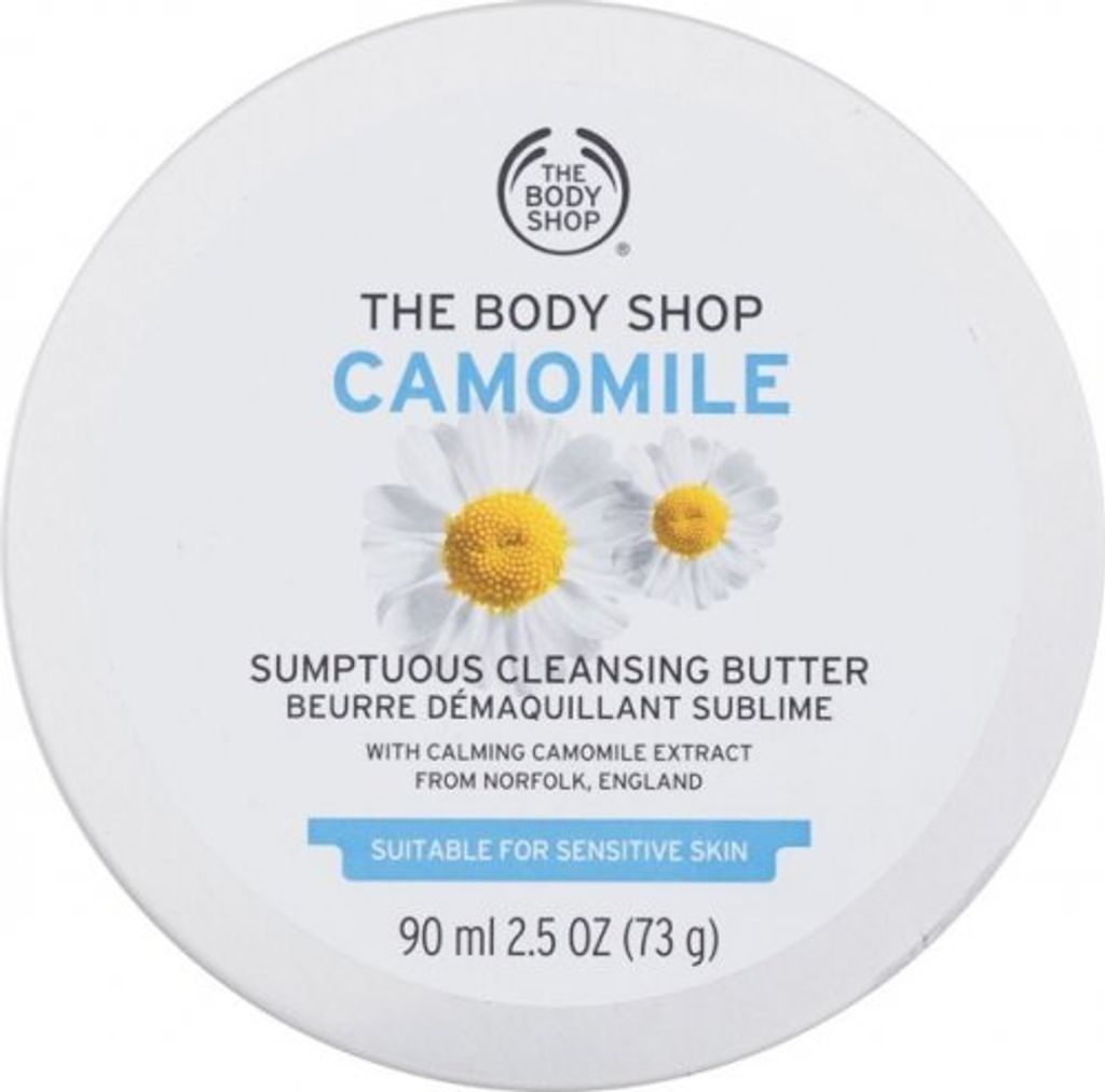 A top-down view of a round white container of The Body Shop Camomile Sumptuous Cleansing Butter.